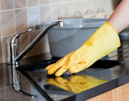 Cleaner treating stains on a living room sofa in Stockwell